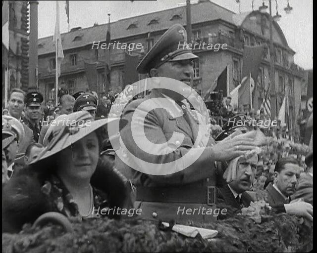 Close up of a German Nazi Party Official in a VIP Section of a Stand With Others Clapping..., 1938. Creator: British Pathe Ltd.