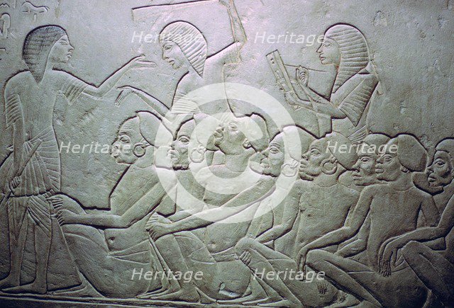 Detail of an Egyptian stele showing an overseer, slaves and scribe. Artist: Unknown