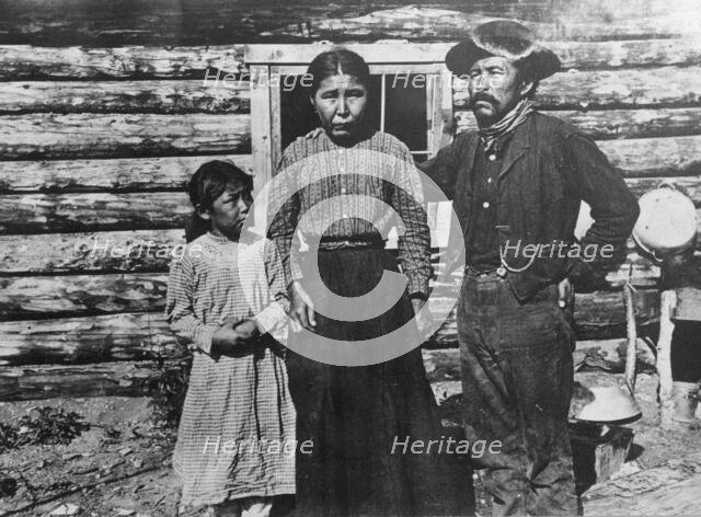Eskimo father, mother and child, between c1900 and c1930. Creator: Unknown.