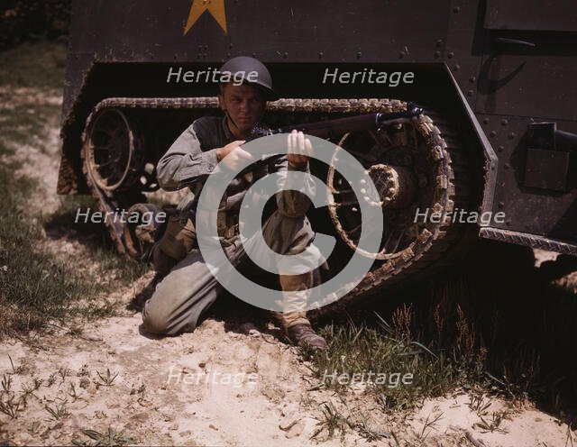 A young soldier of the armored forces holds and sights his Garand rifle like..., Fort Knox, Ky, 1942 Creator: Alfred T Palmer.