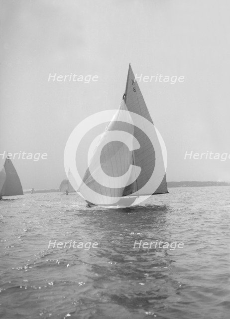The 7 Metre yacht 'Pinaster' (K8) sailing with spinnaker, 1914. Creator: Kirk & Sons of Cowes.