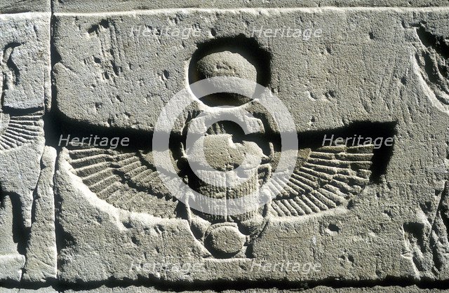 Limestone relief of a scarab beetle and vulture wings under a disk of the sun, Edfu, Egypt. Artist: Unknown