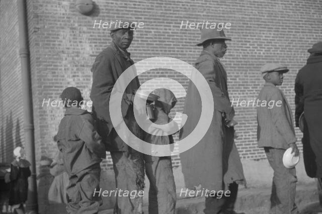 Negroes in the lineup for food at the flood refugee camp, Forrest City, Arkansas, 1937. Creator: Walker Evans.