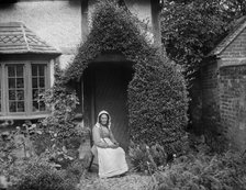 Portrait of an unknown elderly woman sitting outside her cottage, West Ilsley, West Berkshire, 1900. Creator: Henry Taunt.