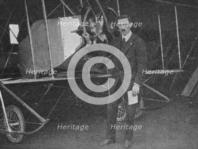 One of the best instructors: Lewis WF Turner standing by a Caudron training biplane, 1913 (1934). Artist: Flight Photo.