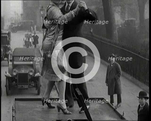 A Couple Dancing the Charleston on the Top of a Car Driving Down a London Street, 1926. Creator: British Pathe Ltd.