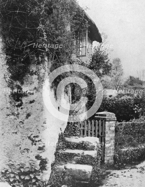 A cottage with an ancient 'upping stock', Cockington, Devon, 1924-1926.Artist: HJ Smith