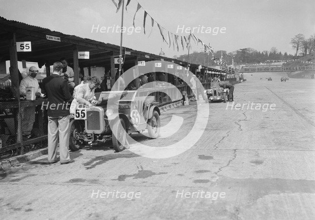 Austin Ulster and MG C type in the pits at the JCC Double Twelve race, Brooklands, 8/9 May 1931. Artist: Bill Brunell.