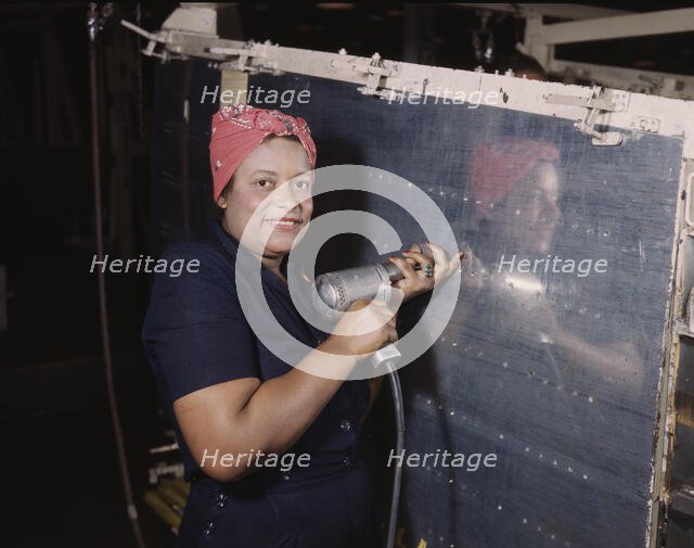 Operating a hand drill at Vultee-Nashville, woman is working on a "Vengeance" dive..., Tenn., 1943. Creator: Alfred T Palmer.