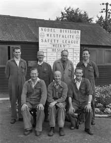 ICI powder works team in front of the Safety League board, Denaby Main, South Yorkshire, 1962. Artist: Michael Walters