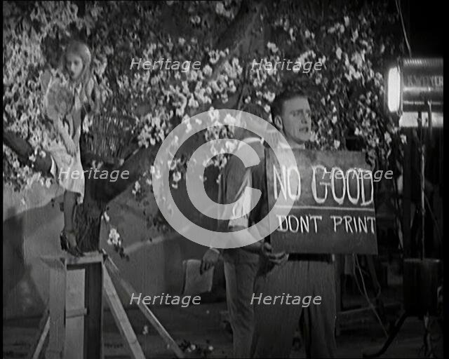 Female Actor Sitting in a Blossom Tree Whilst a Male Civilian Talks to Her..., 1920s. Creator: British Pathe Ltd.