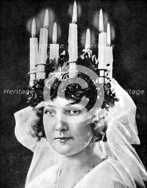 Scandinavian girl wearing candle headdress on St Lucy's Day, 1936.Artist: Fox