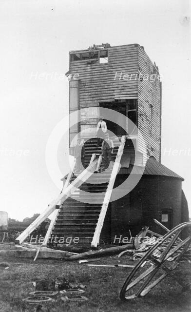 Three men standing on the remains of Golden Cross Windmill, Chiddingly, East Sussex, 1935.  Creator: HES Simmons.