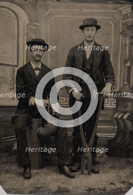 Two Stovepipe Makers, One with a Hammer and Tin Snips..., 1880s. Creator: Unknown.