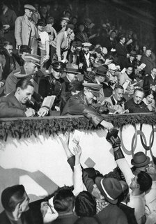 Adolf Hitler signs autographs, Winter Olympic Games, Garmisch-Partenkirchen, Germany, 1936.Artist: Schirner