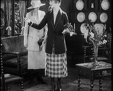 Two Female Civilians Modelling Two Piece Suits and Hats Posing in a Drawing Room, 1920. Creator: British Pathe Ltd.