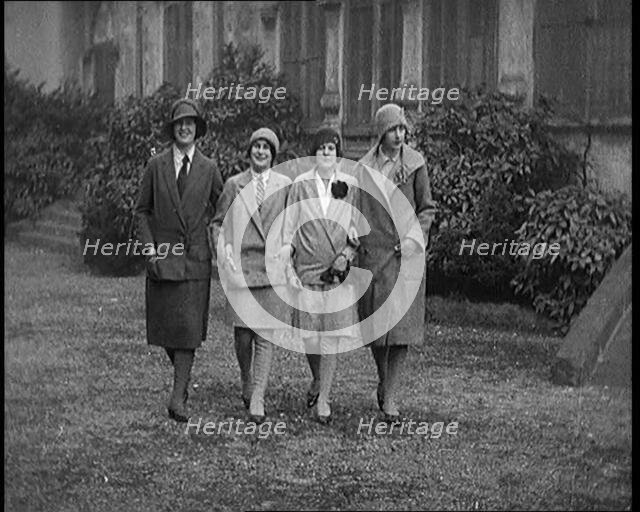 Female Civilians Wearing Glamorous Outfits and Wool Stockings Walking down a Street, 1920. Creator: British Pathe Ltd.