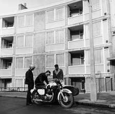 Men with a motorbike, Queen's Crescent, St Pancras, London, 1965.  Artist: Henry Grant