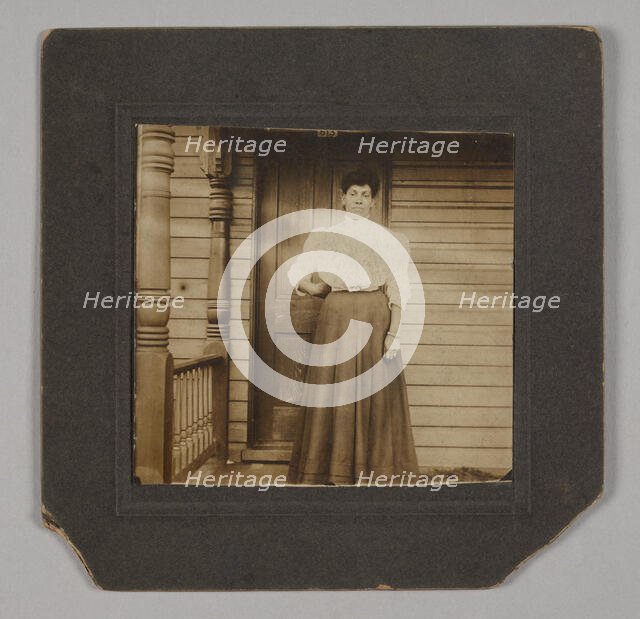 Photographic print of a woman on a porch, early 20th century. Creator: William O. Turner.