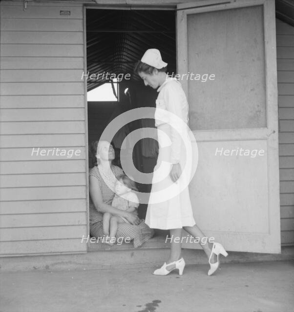 Resident nurse come to visit family, FSA camp, Farmersville, Tulare County, 1939. Creator: Dorothea Lange.