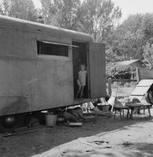 The house trailer and the youngest little girl, Washington, Yakima Valley, Toppenish, 1939. Creator: Dorothea Lange.