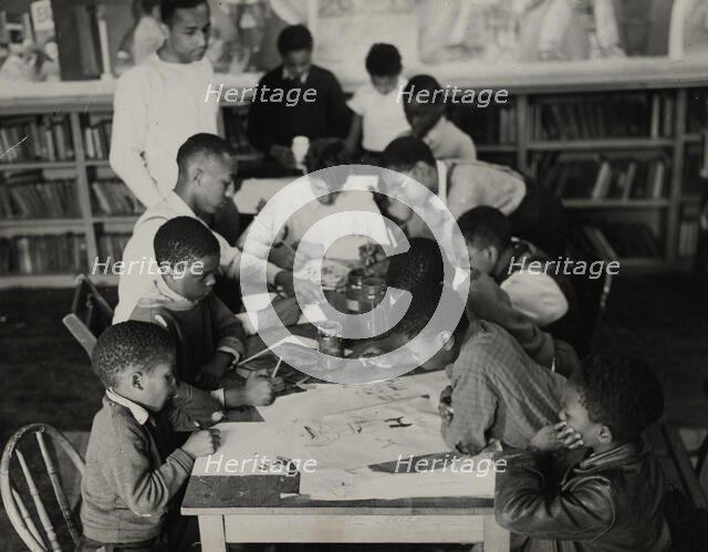 Oliver Harrington supervises class studying mural work, Hudson Ave Boys' Club, 1936. Creator: Andrew Herman.