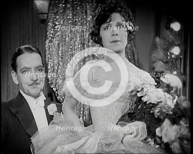 Scene from the Film 'The Compulsory Husband':  a Female Actor Sitting on a Male Actors Lap, 1920s. Creator: British Pathe Ltd.