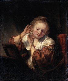 'Young Woman trying on Earrings', 1657.  Artist: Rembrandt Harmensz van Rijn    