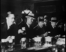 American Civilians Celebrating the End of Prohibition Drinking in a Bar, 1930s. Creator: British Pathe Ltd.