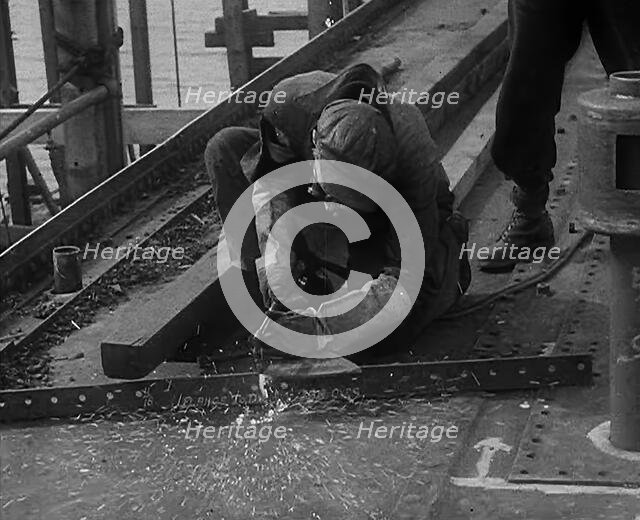 A Factory Worker Constructing Part of a Ship, 1943. Creator: British Pathe Ltd.