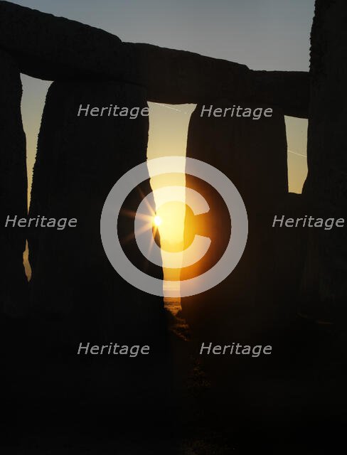 View of Stonehenge, showing the sun's rays glinting through the opening in a trilithon, 2012. Creator: James O Davies.