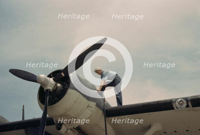 Sailor mechanic fueling a plane at the Naval Air Base, Corpus Christi, Texas, 1942. Creator: Howard Hollem.