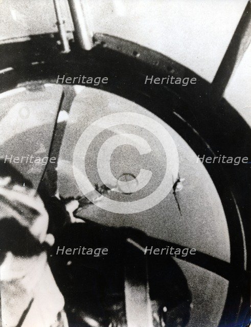 A Spitfire seen from a HE 111K, after diving through the German bomber formation. Artist: Unknown