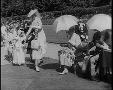 A Young British Girl Approaching the Chair of Queen Mary of Teck With a Purse in Her Hand..., 1939. Creator: British Pathe Ltd.