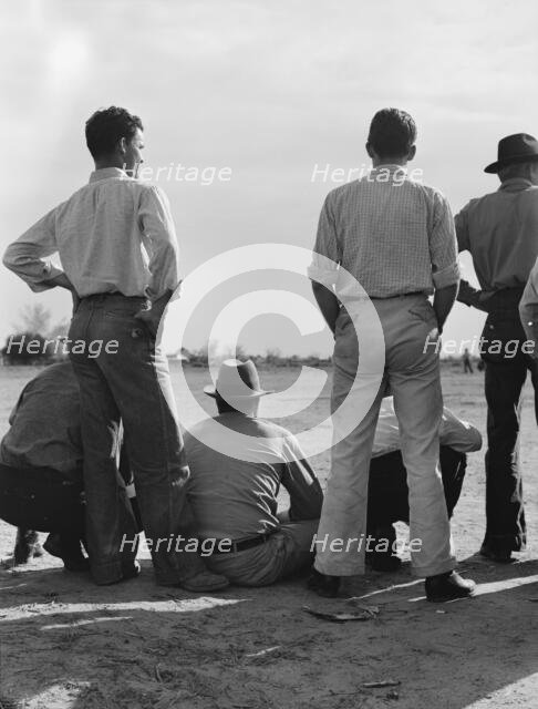 Watching ball game, Shafter camp for migrants, California, 1939. Creator: Dorothea Lange.