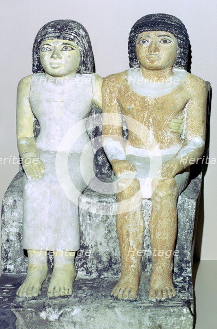 Limestone Egyptian statue of a man and his wife. Artist: Unknown