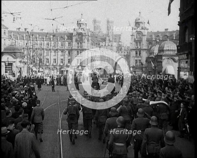 German Soldiers Marching Down a Street as a Crowd Watches, 1930s. Creator: British Pathe Ltd.