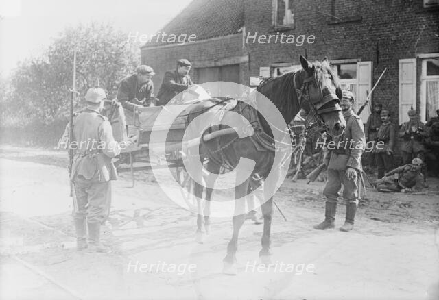 Belgian peasants showing pass to sentries, between 1914 and c1915. Creator: Bain News Service.