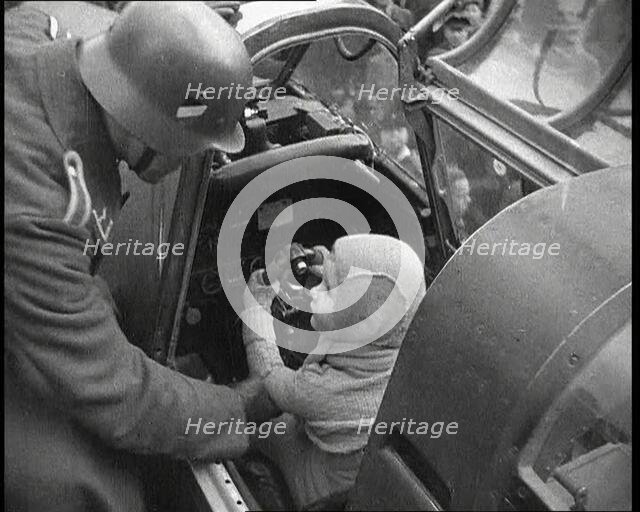 A Young Boy Sitting in the Cockpit of a Fighter Plane, 1930s. Creator: British Pathe Ltd.
