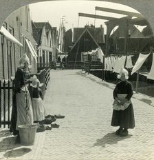 'Washday in Volendam, Netherlands - Shoes Large and Small and Some Who Wear Them', c1930s. Creator: Unknown.