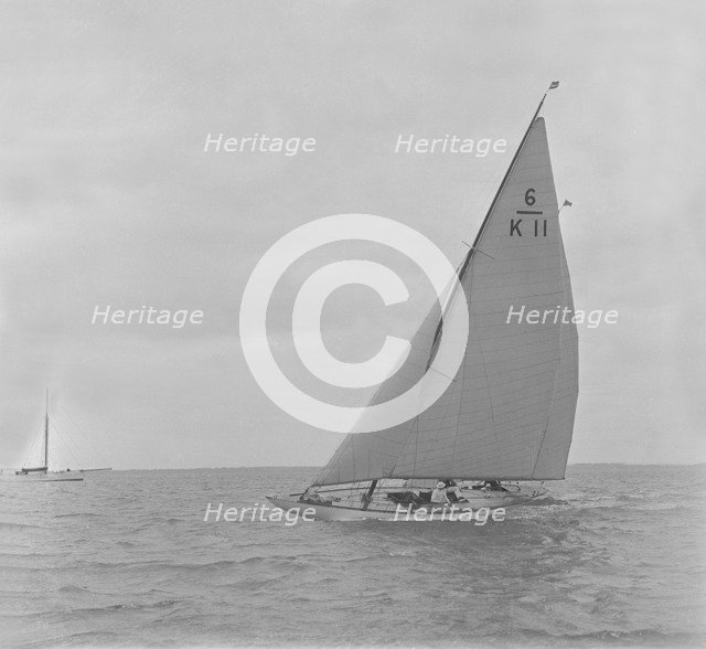 The 6 Metre class 'Freesia' sailing close-hauled, 1921. Creator: Kirk & Sons of Cowes.