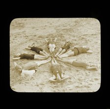 A group of female swimmers lying in a circle on the beach probably at Clacton-on-Sea..., 1920s.  Creator: Norman Kingsley Harrison.