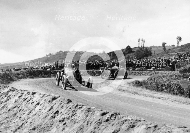 J Chassagne in the Sunbeam leading Jules Goux in the Peugeot, French Grand Prix, Lyons, 1914. Artist: Unknown
