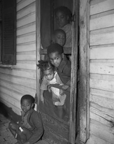 Negro children in the front door of their home, Washington (southwest section), D.C., 1942. Creator: Gordon Parks.