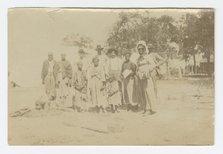 Photograph of men, women, and children in a yard, early 20th century. Creator: Unknown.