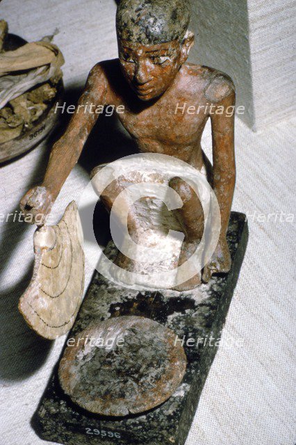 Wooden Model of Man fanning Fire, Egyptian  Tomb Finding, c1900 BC.  Artist: Unknown.