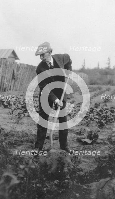 Frank G. Carpenter in a garden, between c1900 and 1916. Creator: Unknown.
