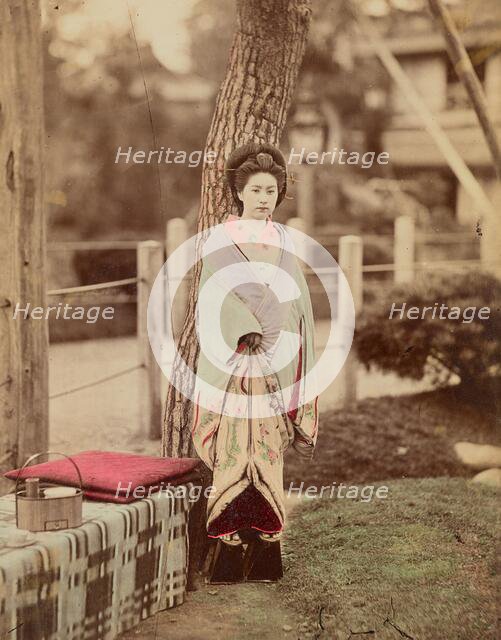 Girl standing near tree, 1870s-1890s. Creator: Kusakabe Kimbei.