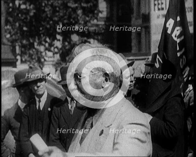 Male Civilian With Small Round Glasses and a Moustache Speaking.  Behind Are Male Civilians..., 1924 Creator: British Pathe Ltd.