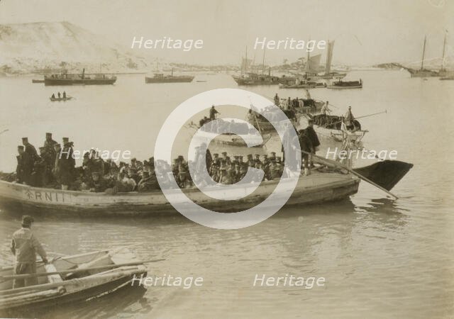 String of pontoons in tow of stream launch, approaching landing stage, Chemulpo, c1904. Creator: Robert Lee Dunn.